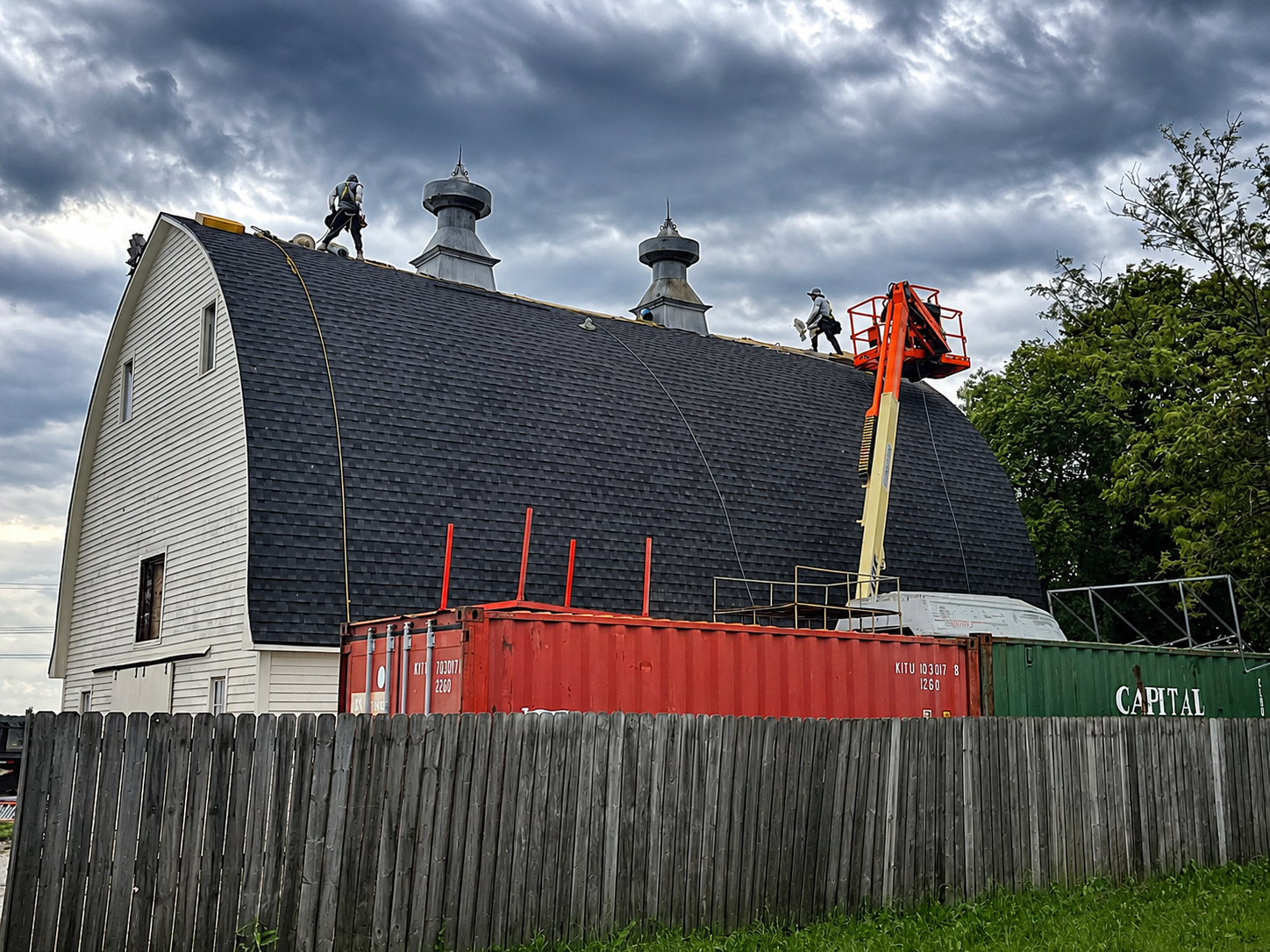 Roofing crew working a shingle tear-off in the Omaha area